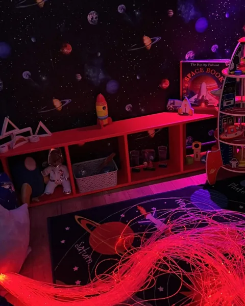 Colourful lights and space-themed play equipment in the Space Station